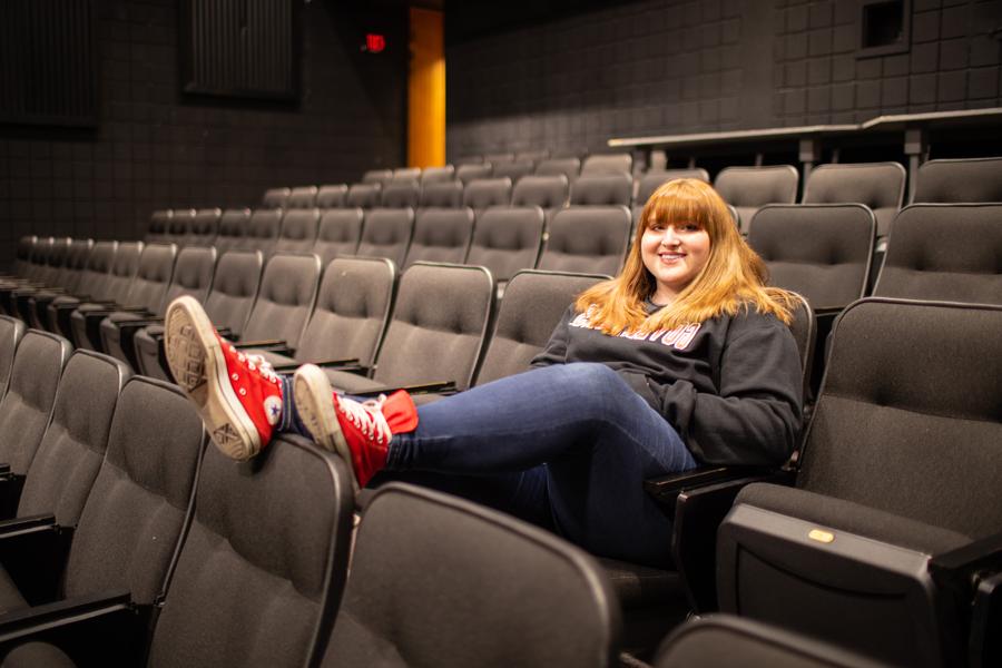 Alyssa Amos sitting in an auditorium.